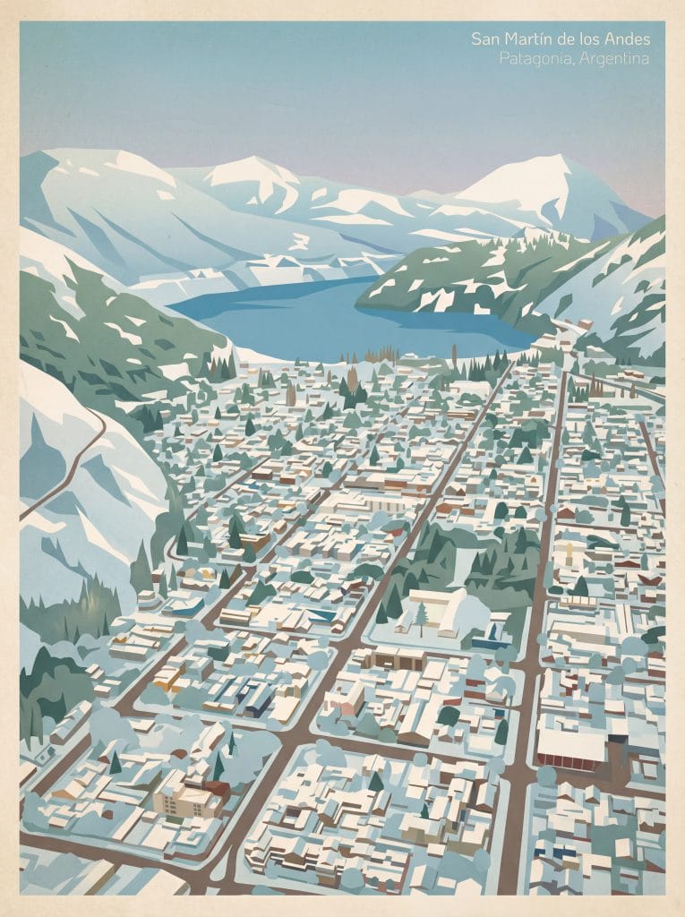Paisaje urbano de San Martín de los Andes con montañas nevadas y lago en el fondo.